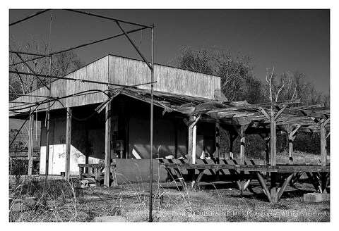 BW photograph of the main building of an abandoned nursery.